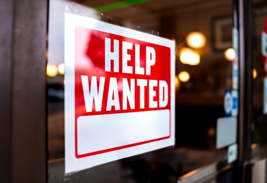 help wanted sign in a window.