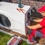 Photo of a HVAC technician fixing an AC.