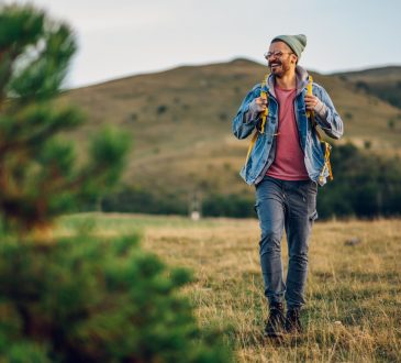 Man smiling while walking in nature