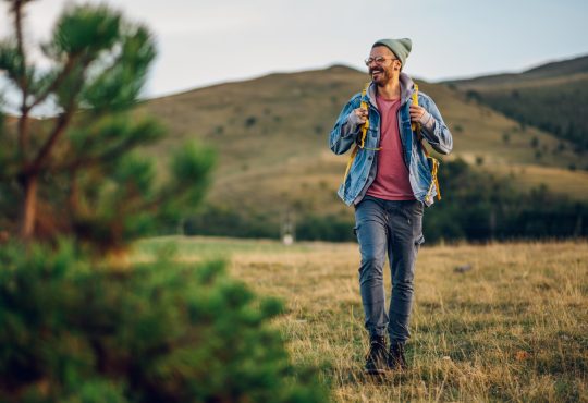 Man smiling while walking in nature