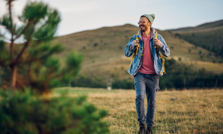 Man smiling while walking in nature