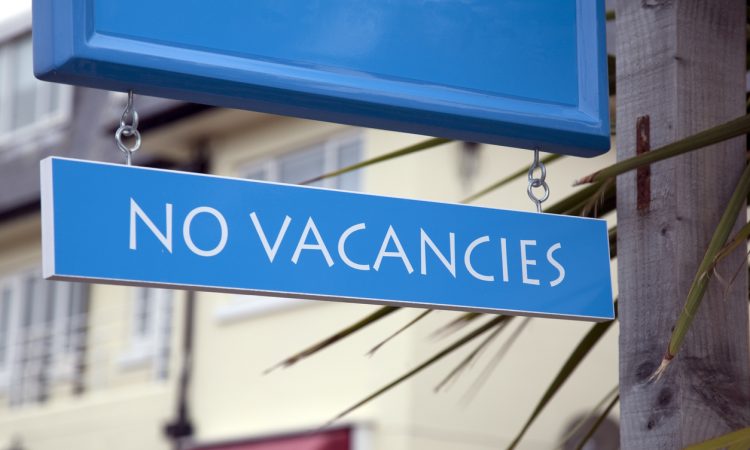 Blue No Vacancies Sign in front of Hotel