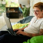 Person working on laptop on bean bag