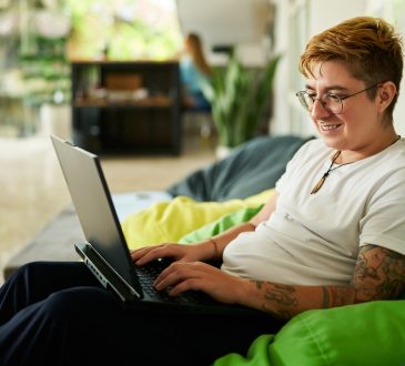 Person working on laptop on bean bag