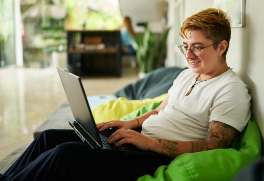 Person working on laptop on bean bag