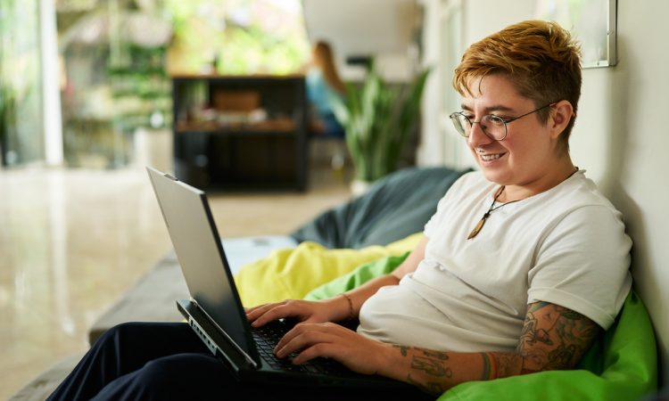 Person working on laptop on bean bag