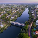 A drone captured view looking towards the central business district (CBD) from the Fairfield Bridge over the Waikato River as it cuts through the city of Hamilton, in Waikato, New Zealand.