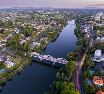 A drone captured view looking towards the central business district (CBD) from the Fairfield Bridge over the Waikato River as it cuts through the city of Hamilton, in Waikato, New Zealand.