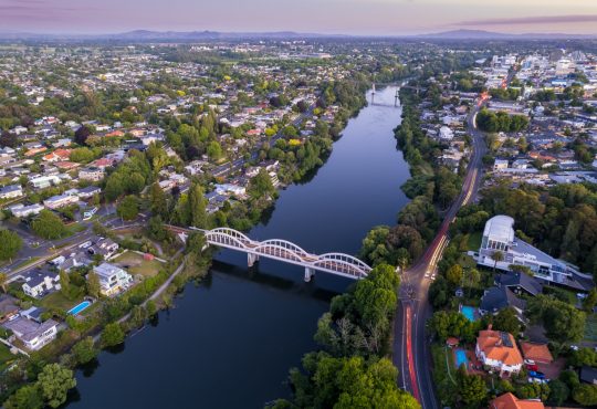 A drone captured view looking towards the central business district (CBD) from the Fairfield Bridge over the Waikato River as it cuts through the city of Hamilton, in Waikato, New Zealand.