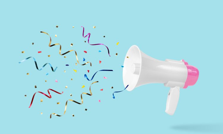 White megaphone with colourful confetti coming out of it