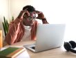 Stressed student sitting at laptop