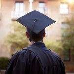 Student wearing graduation cap pictured from behind