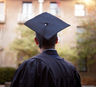 Student wearing graduation cap pictured from behind