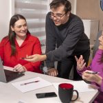 Three people working in computer at office