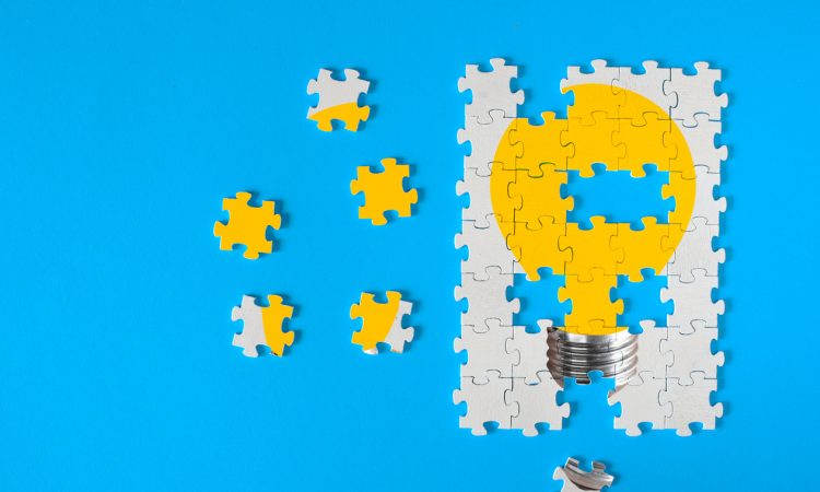 Puzzle pieces making up lightbulb