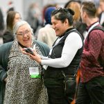 Delegates smiling and talking in lobby at Cannexus25