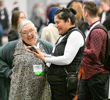 Delegates smiling and talking in lobby at Cannexus25