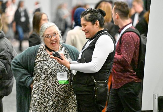 Delegates smiling and talking in lobby at Cannexus25