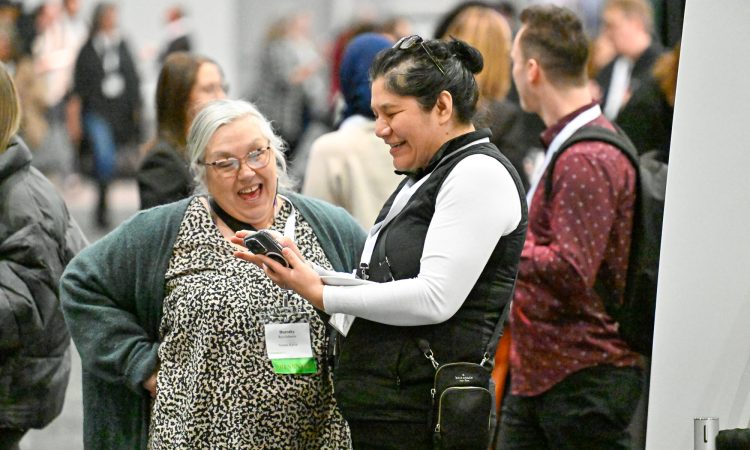 Delegates smiling and talking in lobby at Cannexus25