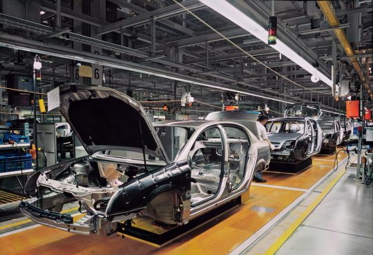 car production line with unfinished cars in a row