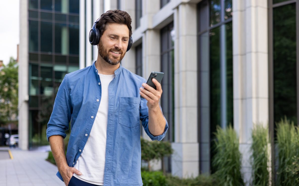 Man walking outside while wearing headphones