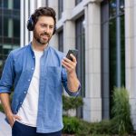 Man walking outside while wearing headphones