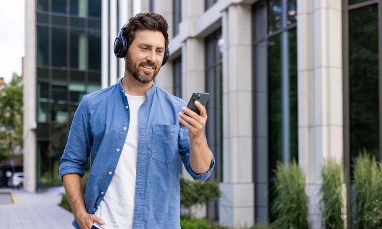 Man walking outside while wearing headphones