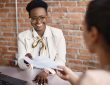 Woman smiling and holding resume during interview