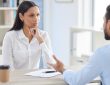 Mixed race hiring manger in interview with businessman.