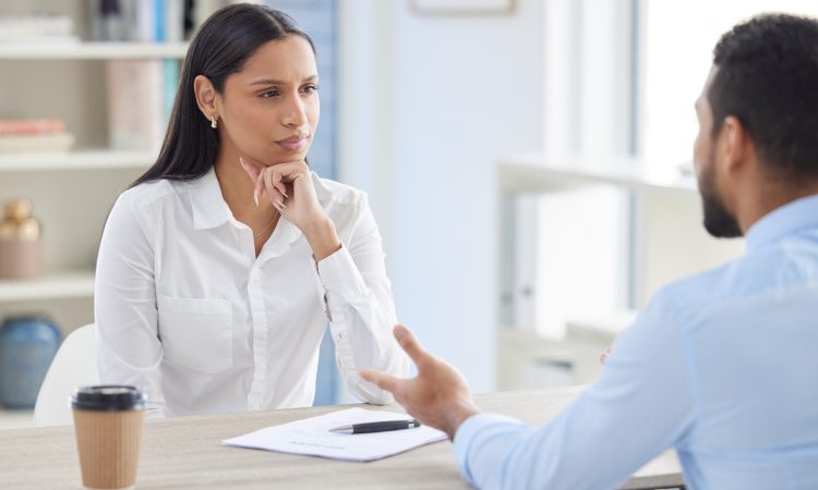 Mixed race hiring manger in interview with businessman.