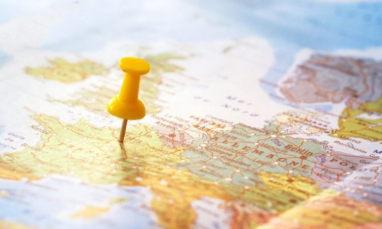 Yellow pin sticking into world map