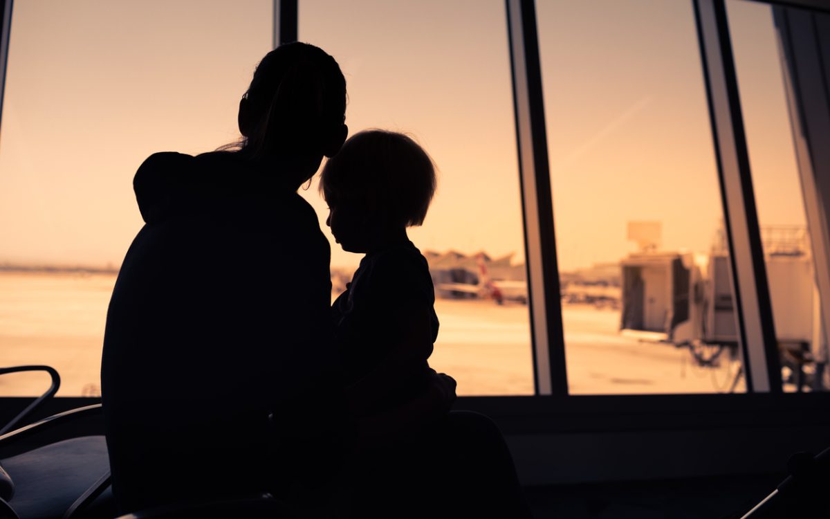 Mother and her little son waiting for boarding in the airport.