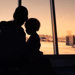 Mother and her little son waiting for boarding in the airport.