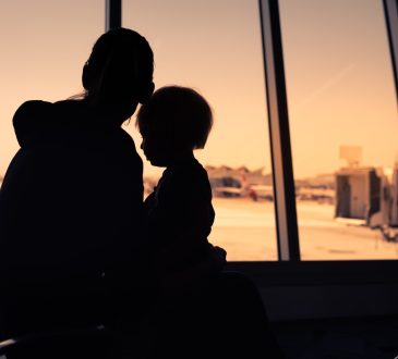 Mother and her little son waiting for boarding in the airport.