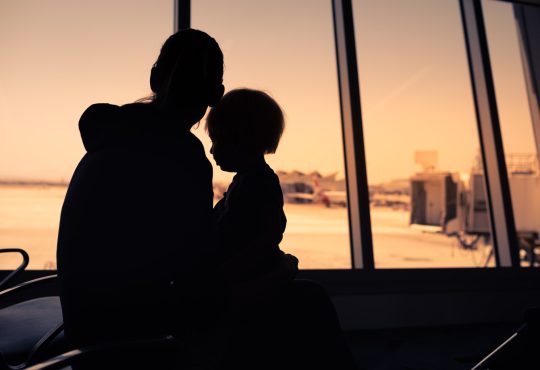Mother and her little son waiting for boarding in the airport.
