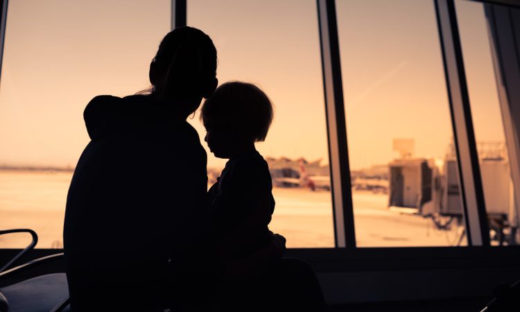 Mother and her little son waiting for boarding in the airport.