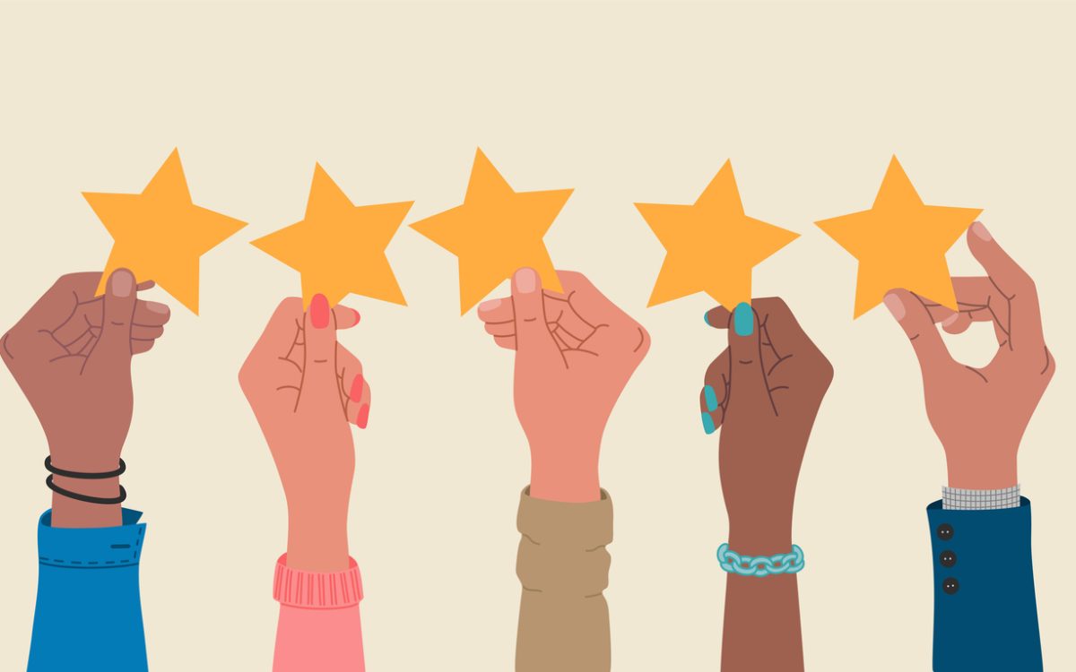 Group of hands holding a five stars rating.
