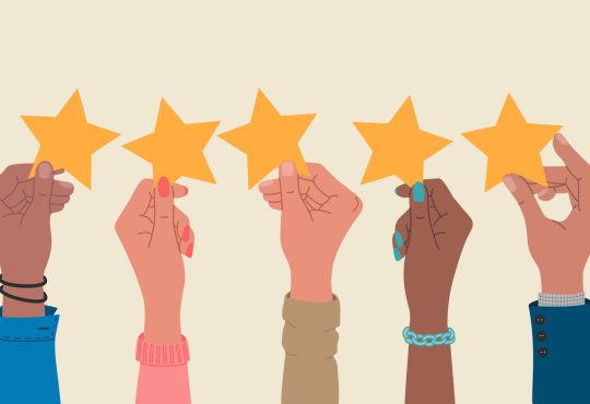 Group of hands holding a five stars rating.