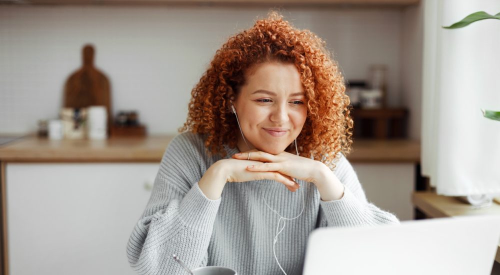Woman watching video on laptop