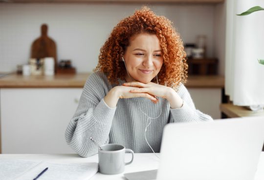 Woman watching video on laptop