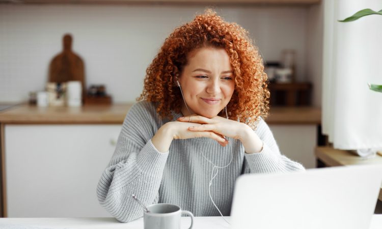 Woman watching video on laptop