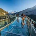 Tourists standing on glass-floored observation deck at Jasper National Park