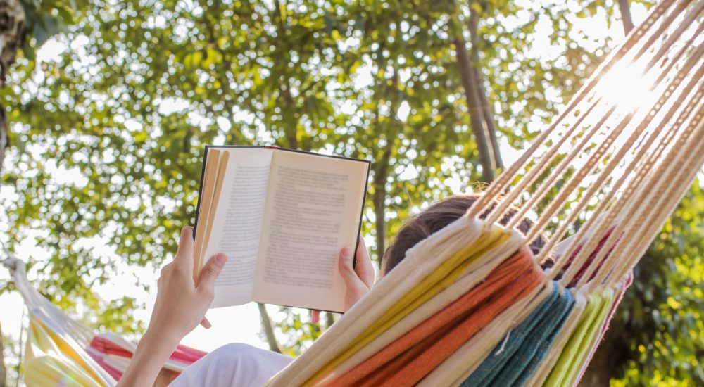 Person reading in hammock