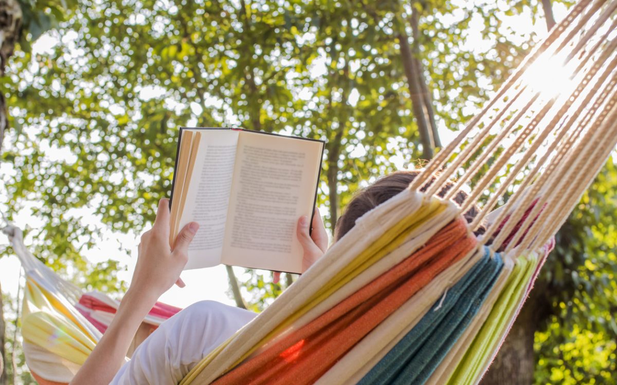 Person reading in hammock