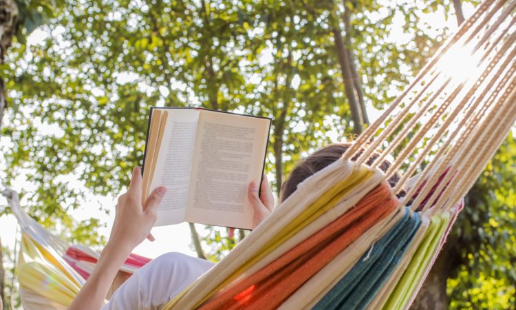 Person reading in hammock