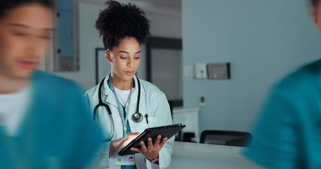 Doctor looking at tablet in hospital
