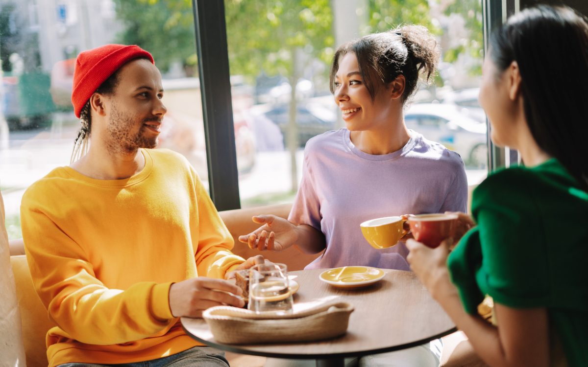 Three people talking in coffee shop