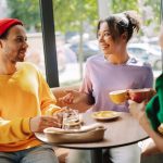 Three people talking in coffee shop