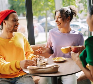 Three people talking in coffee shop
