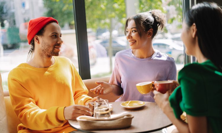 Three people talking in coffee shop